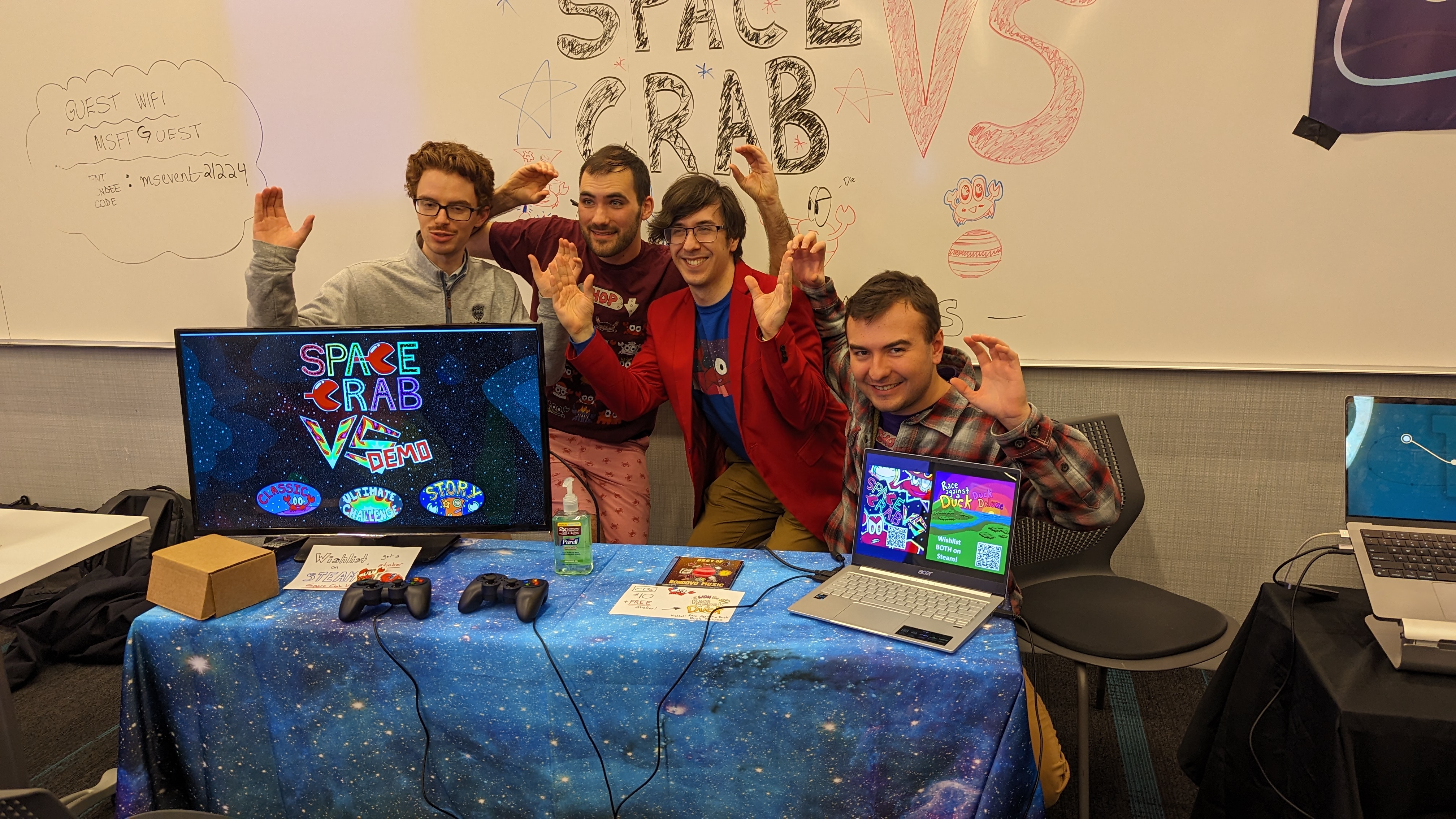 The team behind Space Crab VS posing for a group photo at their booth demo'ing the desktop version of the game at the Playcrafting Mini Expo